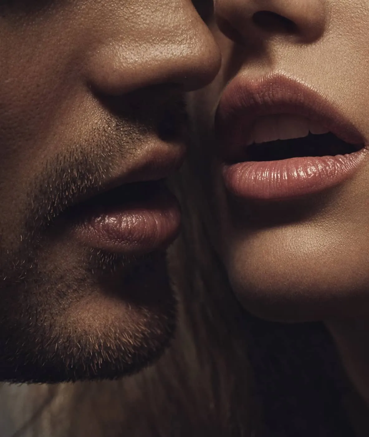 Close-up of a man and woman’s lips in an intimate, near-kissing pose.