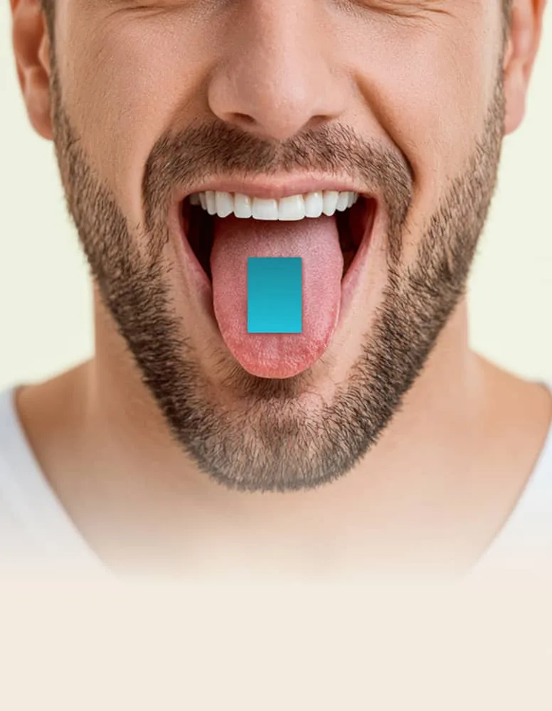 Close-up of a bearded man with mouth open and tongue out holding a blue tablet on his tongue.