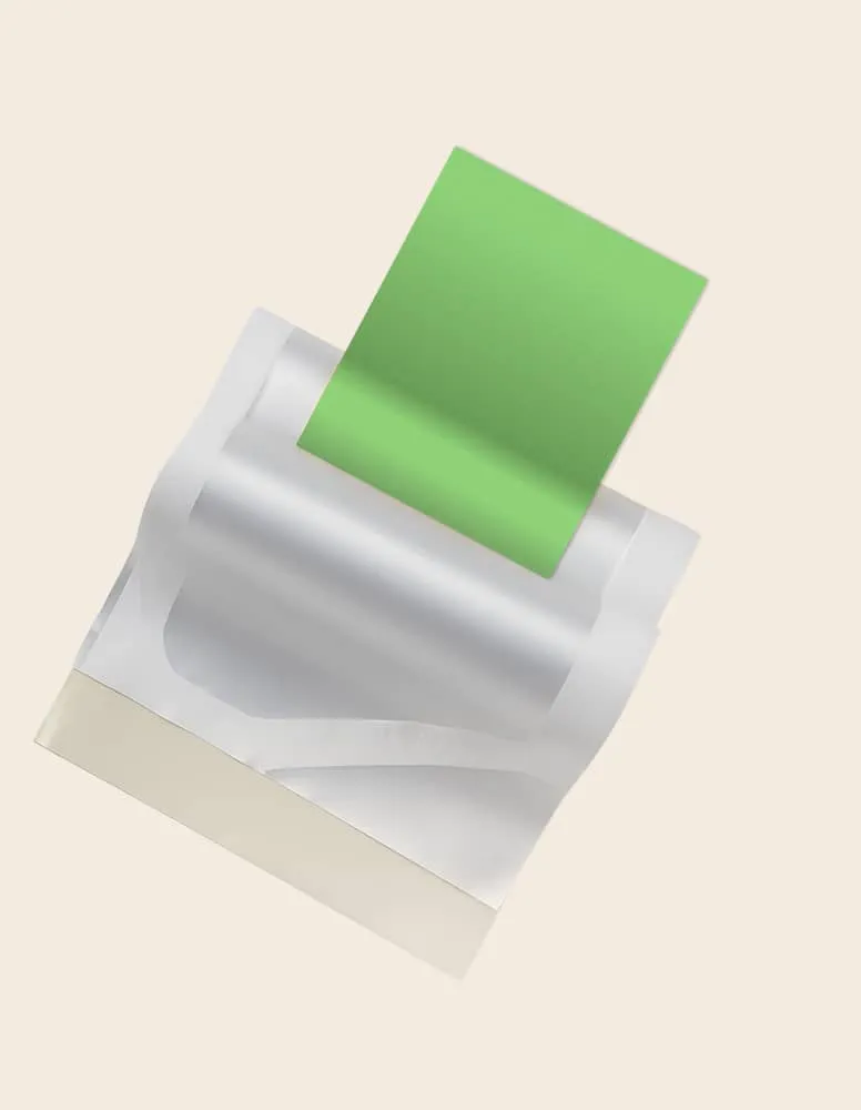 White open pouch with a green rectangular sheet partially inserted inside it on beige background.