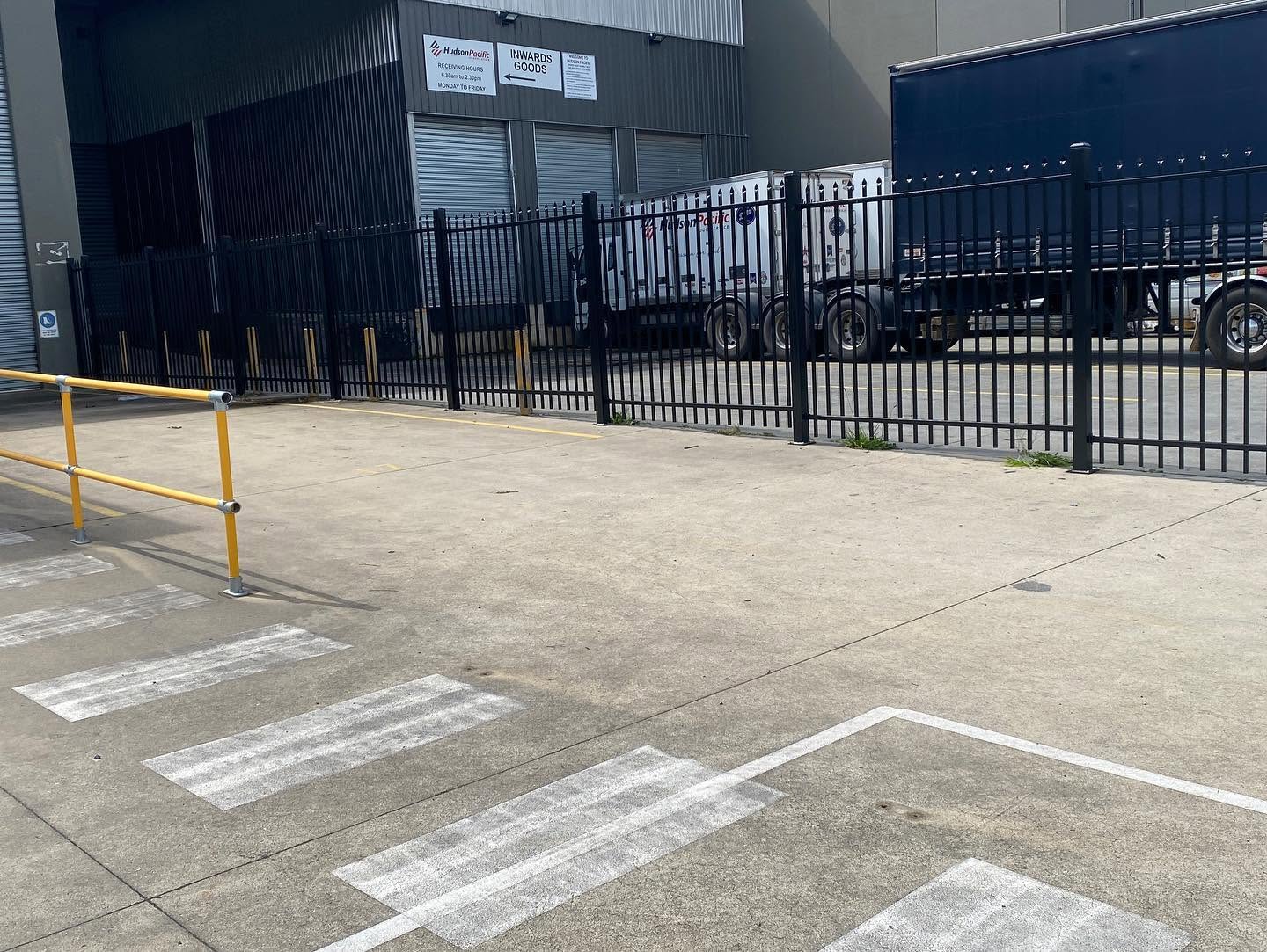 Commercial perimeter-fence panels with coordinated cantilever-gate post interface