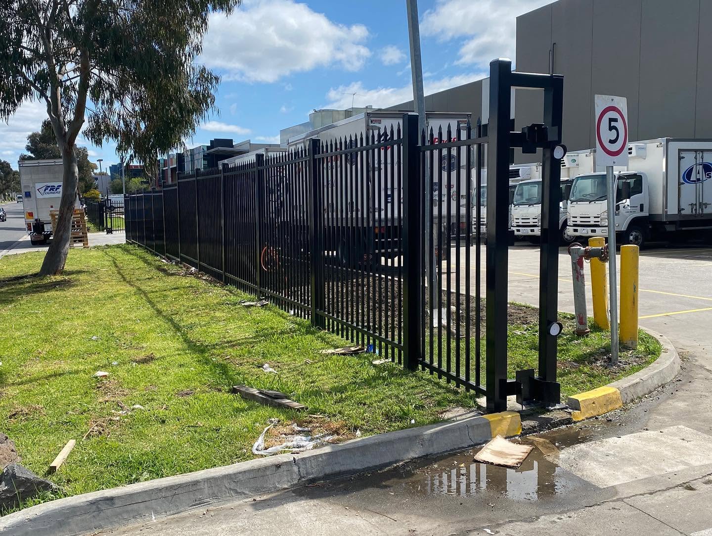 Black spear-top security fencing and cantilever gate at Hudson Pacific commercial site