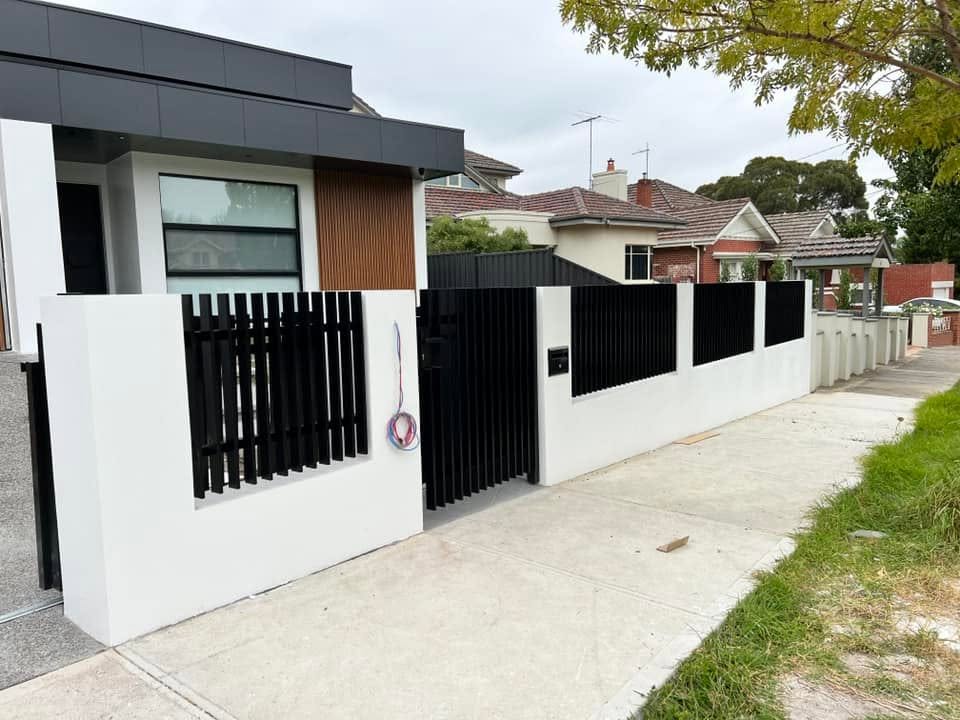 Electric sliding driveway gate with vertical aluminium blade infill for contemporary private residence in Strathmore Victoria