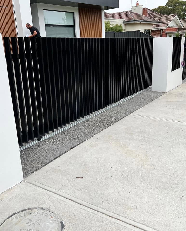 Black architectural blade fencing complementing timber-look façade cladding in Strathmore Victoria