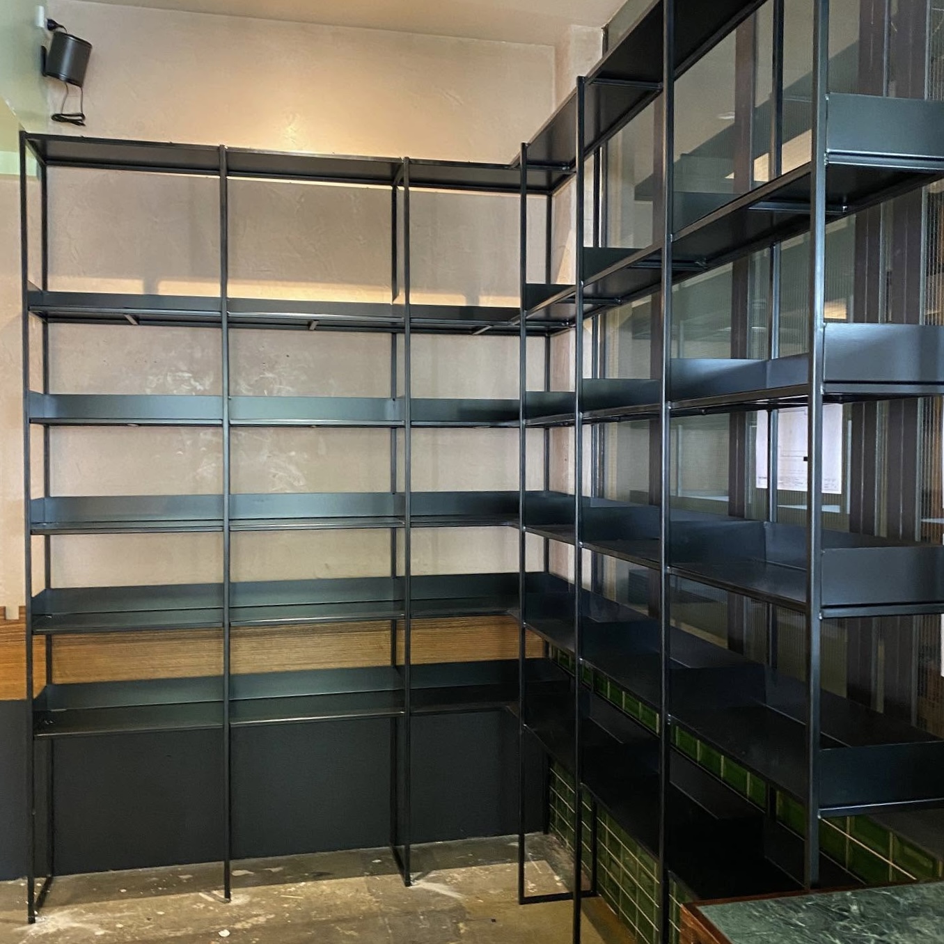 GSP Engineering dark-finished metal product-display shelving installed in a Fitzroy coffee shop