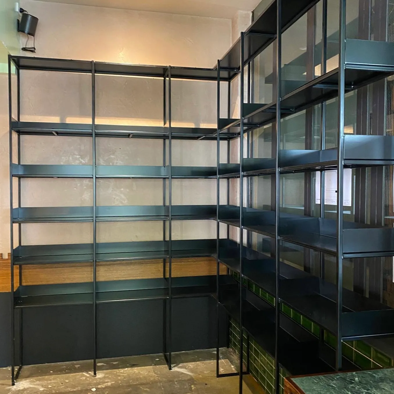 GSP Engineering dark-finished metal product-display shelving installed in a Fitzroy coffee shop