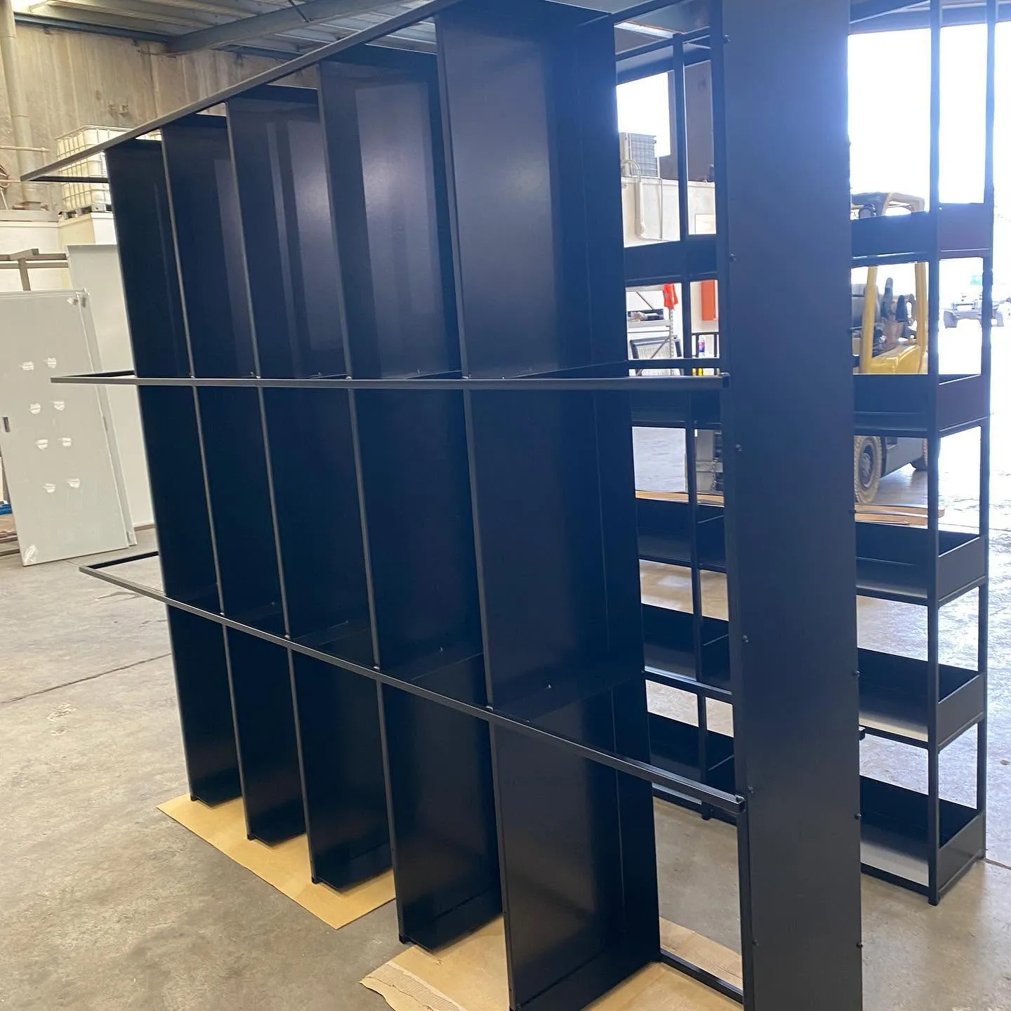 Dark metal hospitality shelving integrated with timber trim and interior finishes