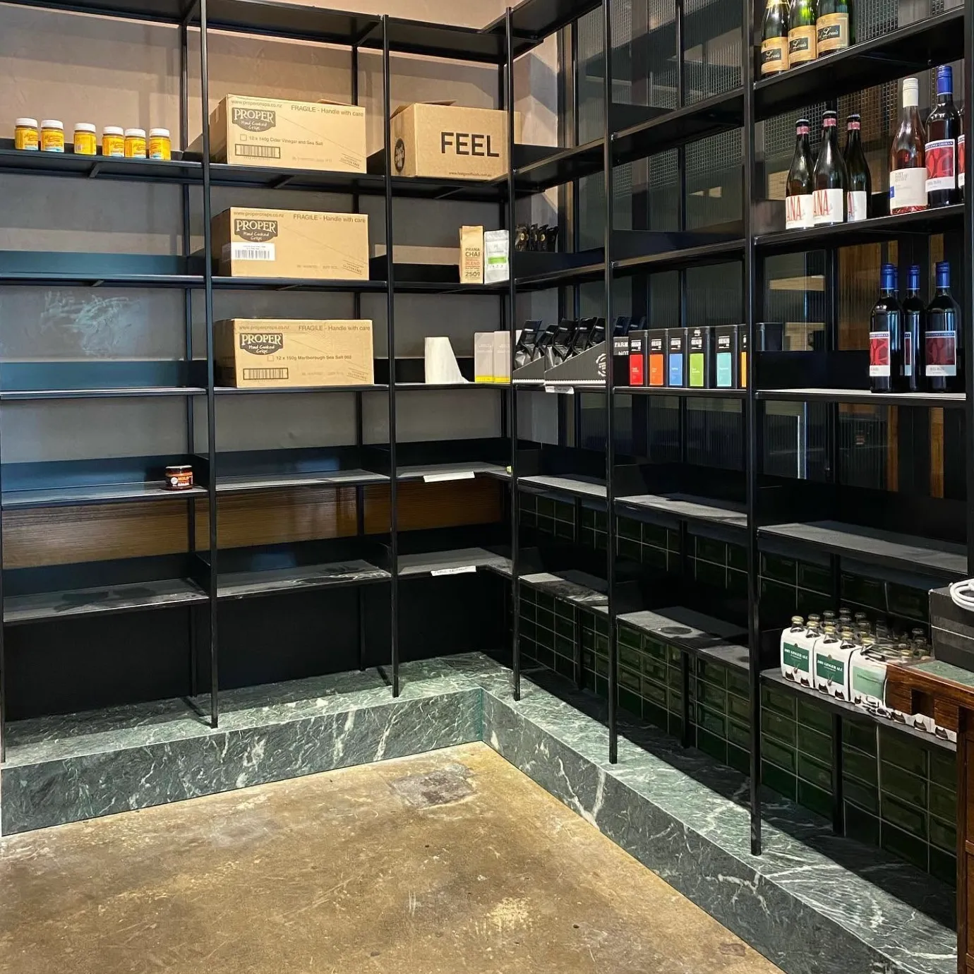 Bespoke hospitality shelving stocked with bottles, jars and packaged goods