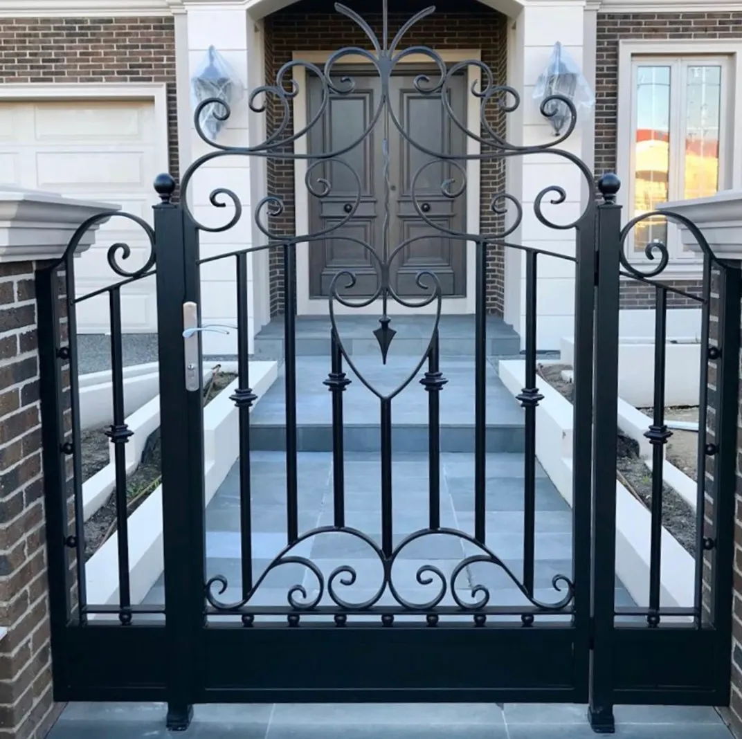 GSP Engineering Client-designed ornamental steel entry gate with decorative scrollwork and side panels