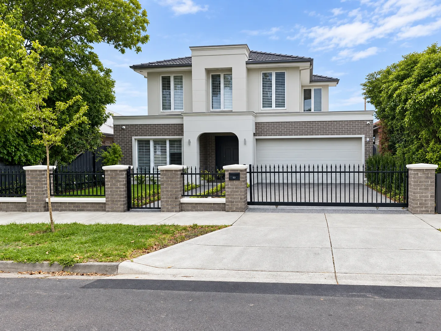GSP Engineering matte-black spear-top fencing and matching driveway gate at a Pascoe Vale residence
