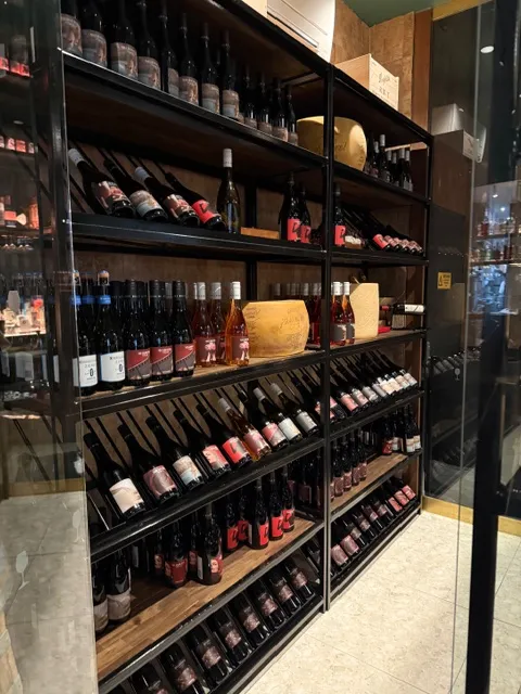 Upright bottle displays and angled presentation rows in bespoke wine racking