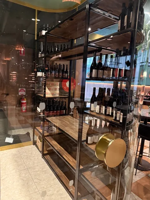 Dark metal wine-rack framing with warm timber display shelving