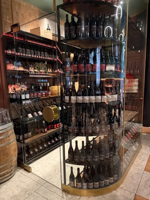 Curved glass wine-room frontage with custom bottle display shelving