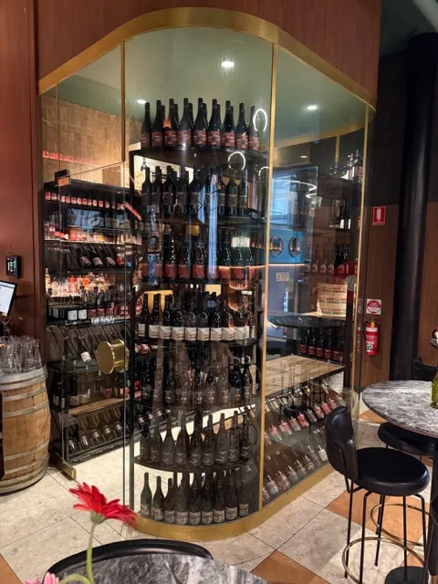 Curved glass wine-room frontage with custom bottle display shelving