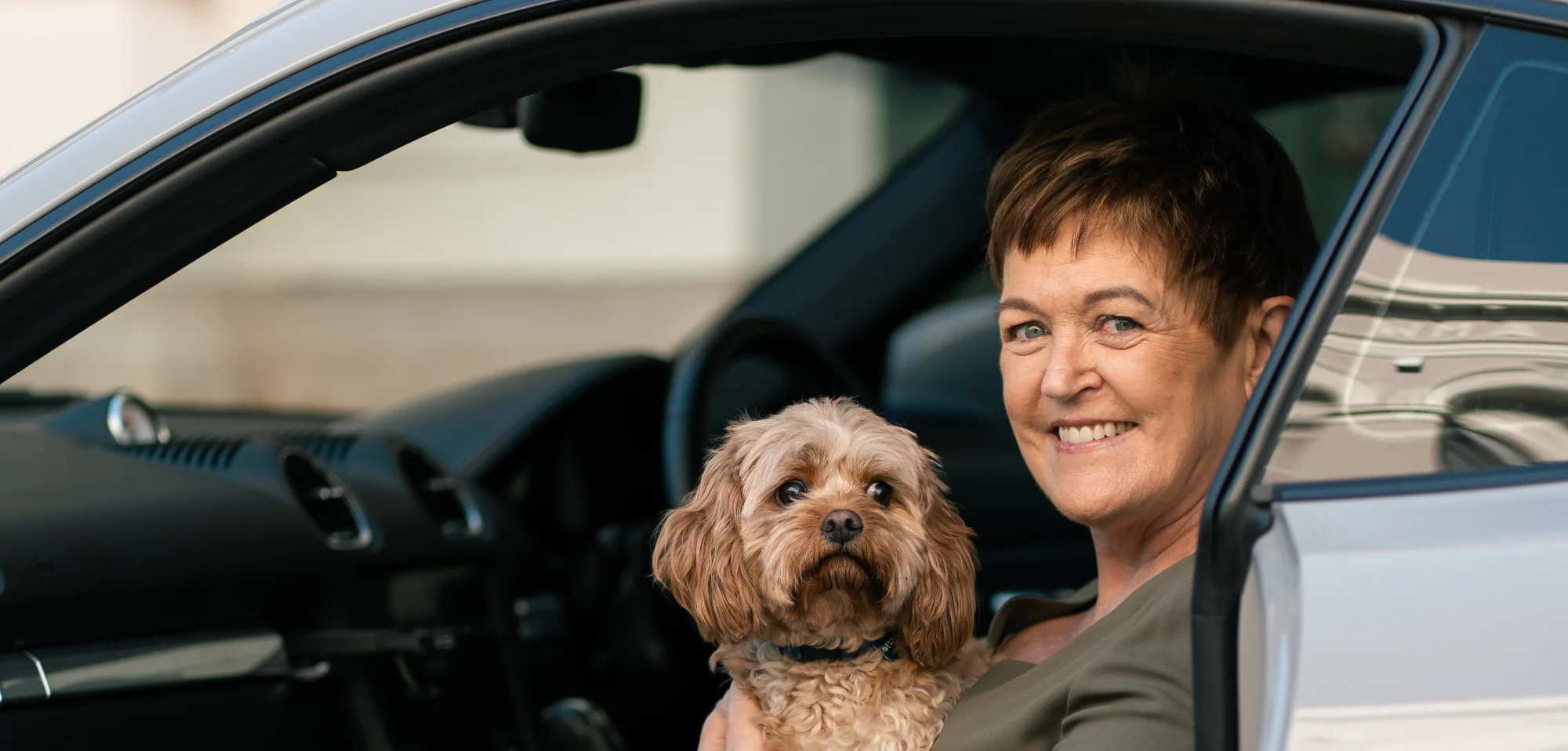 Gill McLean of Dream Freedom Financial in her car with her dog Ruby