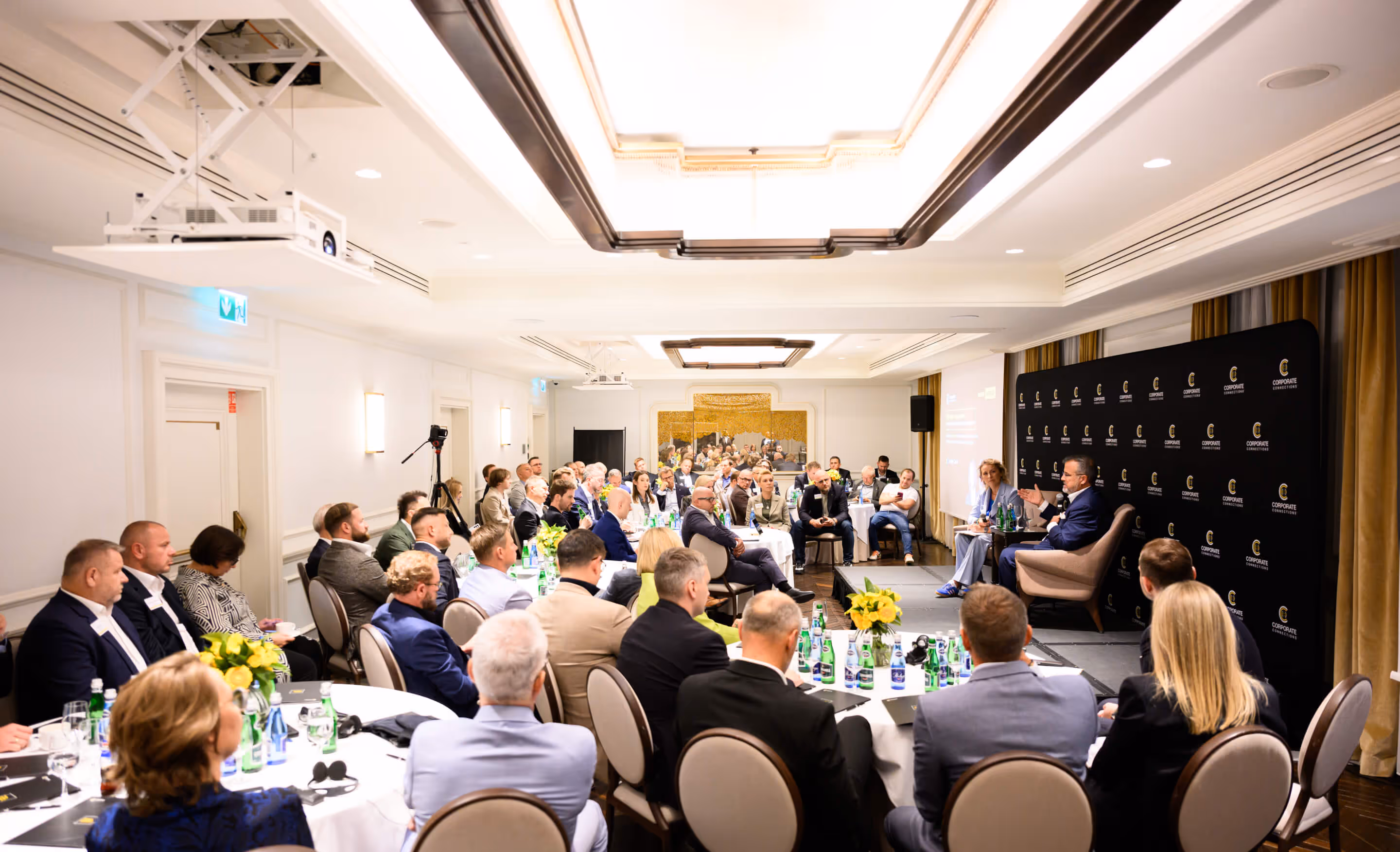 A large group of members seated in a ballroom during a CC US chapter meeting
