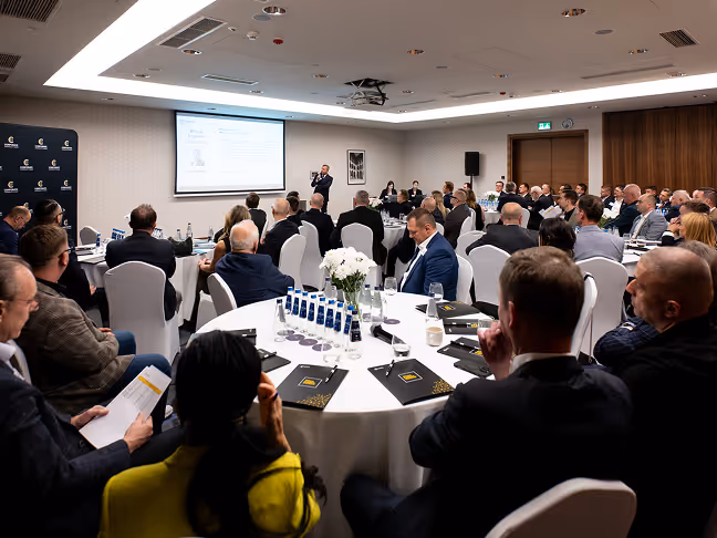 Members seated at tables during a CC US chapter meeting