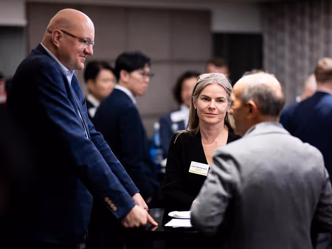 Members talking in small groups at a CC US chapter meeting