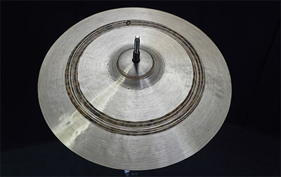 A handmade Collingwood Cymbal showing hand-hammering and lathing under the light