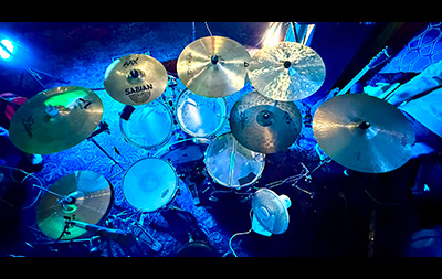 A cymbal made at a Make Your Own Cymbal session on a full drum kit at a gig setting