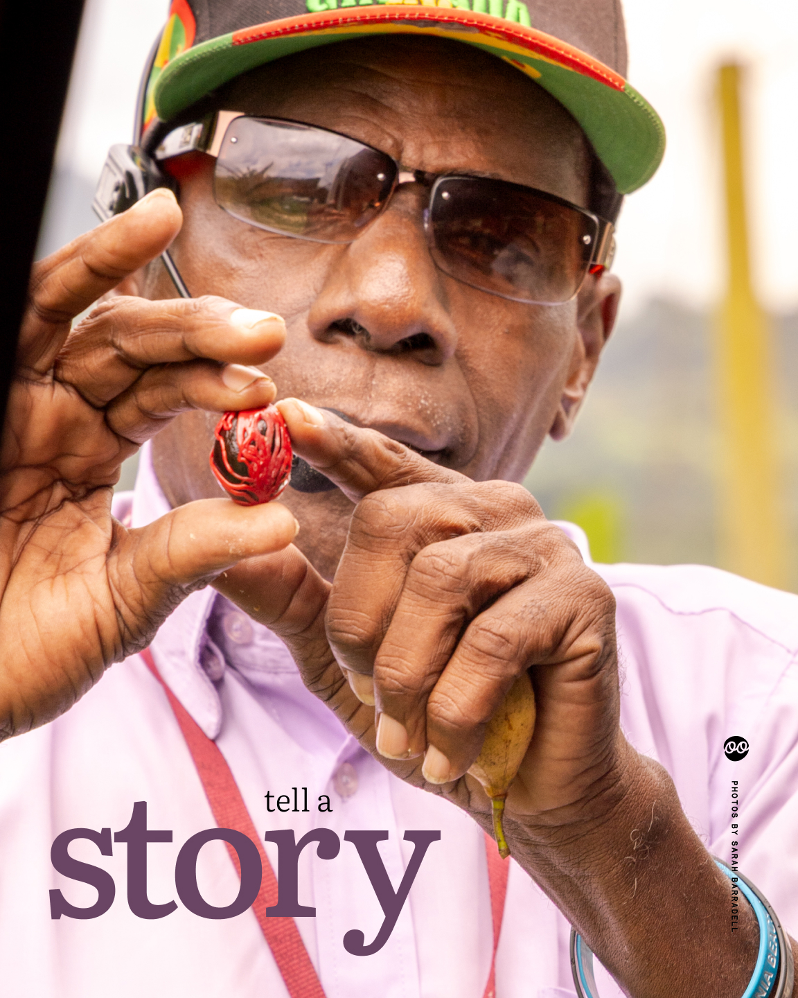Close-up portrait of a man in sunglasses and a cap holding up a small nutmeg (native to Grenada, where he's from) between his fingers, overlaid with the words âtell a storyâ.