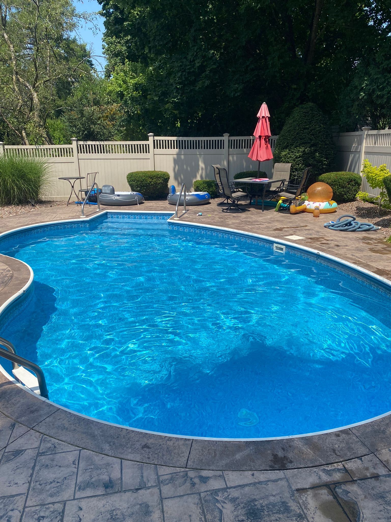 Backyard swimming pool maintained by Queen City Pools in Liverpool, NY
