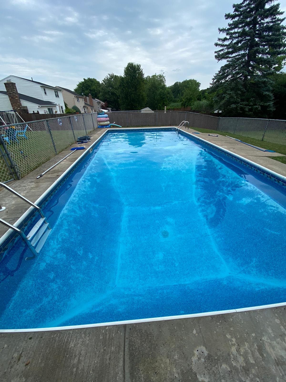 Backyard pool cared for by Queen City Pools in Liverpool, NY