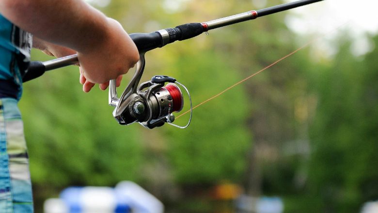 Person holding a fishing pole, representing the Texas hunting and fishing license data breach