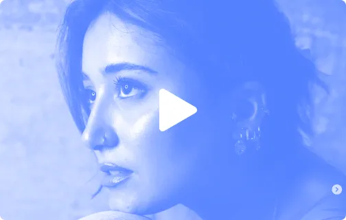 Close-up of a woman gazing to the left with a play button overlay.