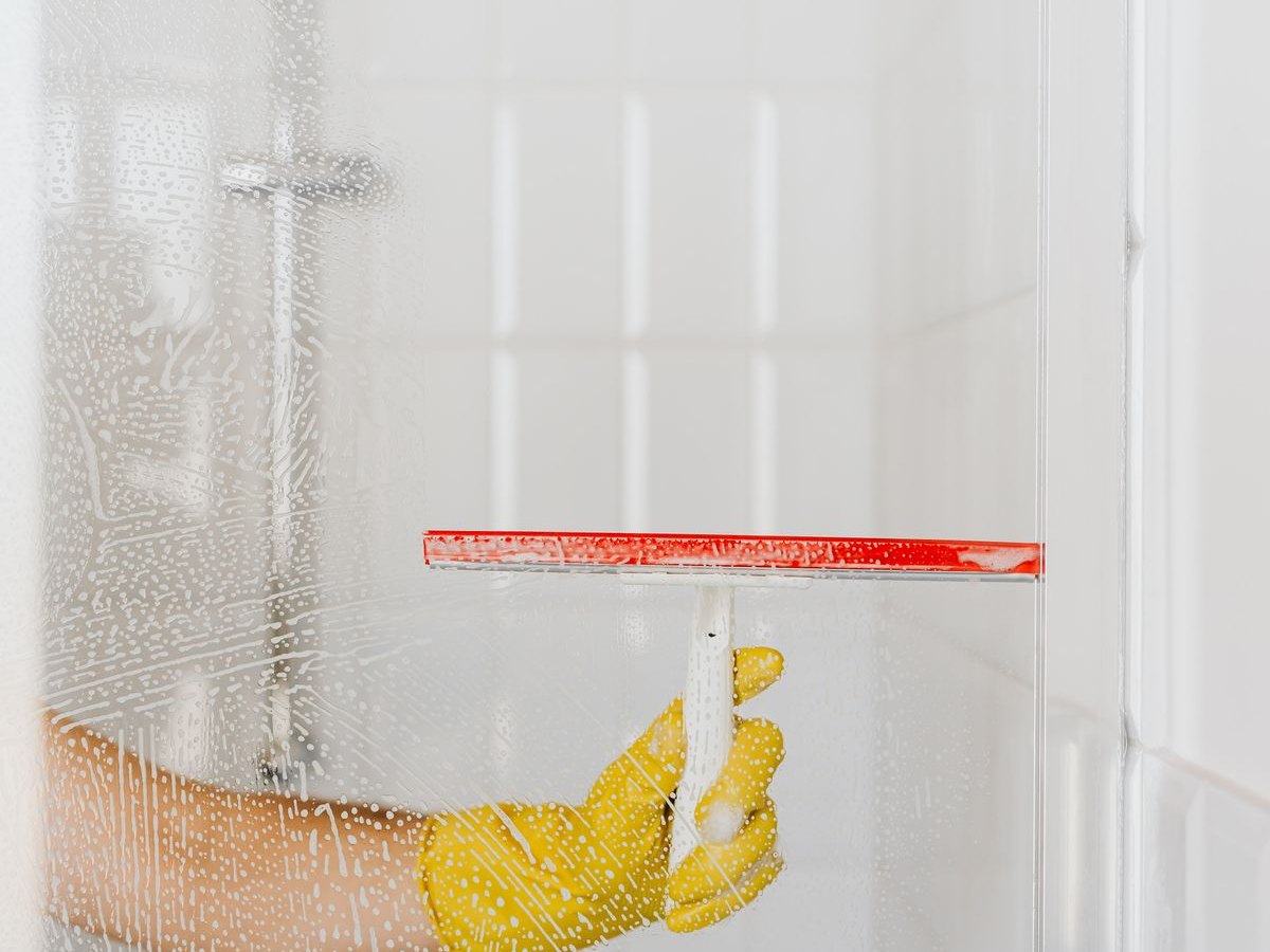 House Cleaning — squeegeeing a shower door