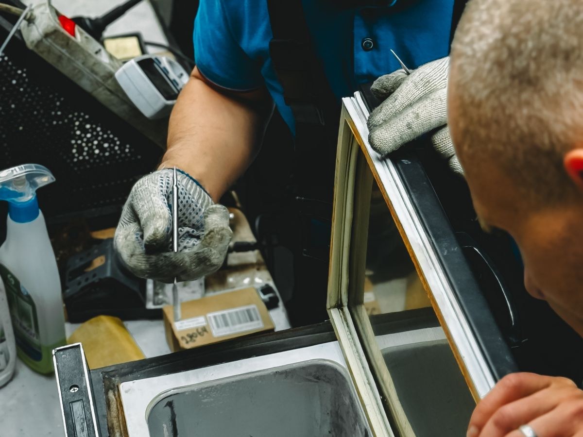 Appliance repair — technician working on a home appliance