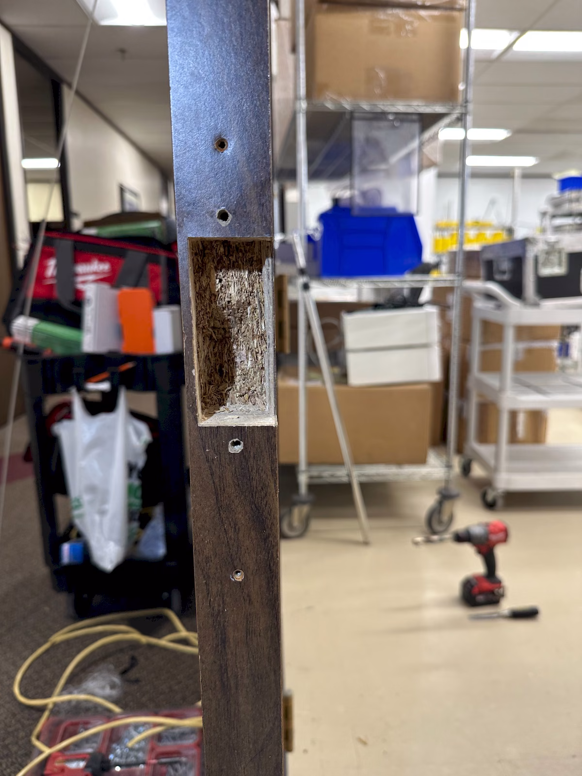 Commercial wood door edge being prepared for installation of an electric strike.