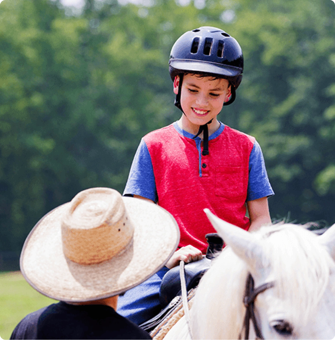 Young rider on a white horse with instructor at Kay's Acres