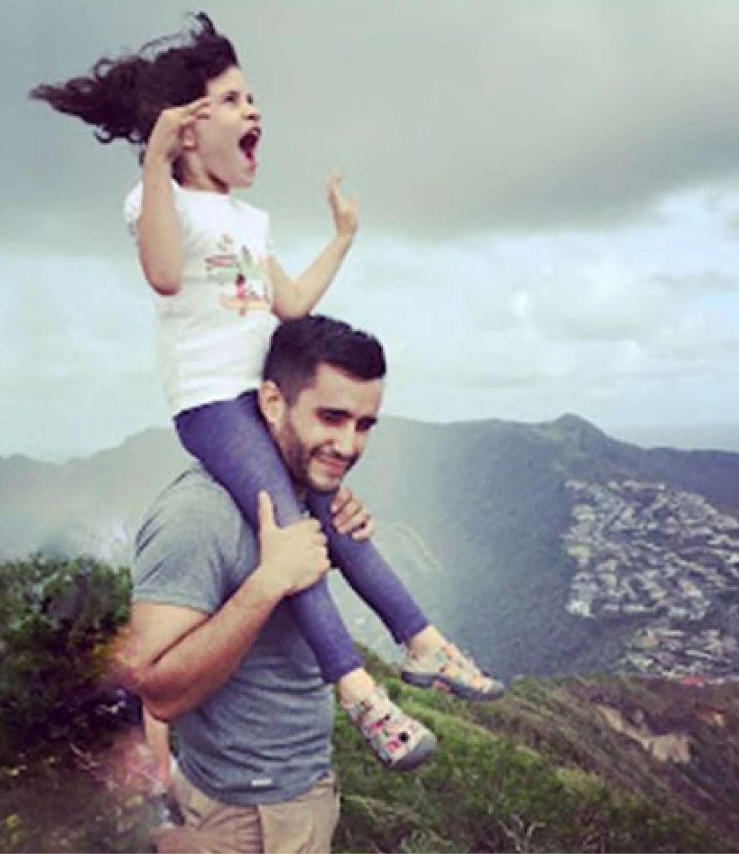Kay riding her Dad's (Joe Musicaro) shoulders in front of a wide vista view.