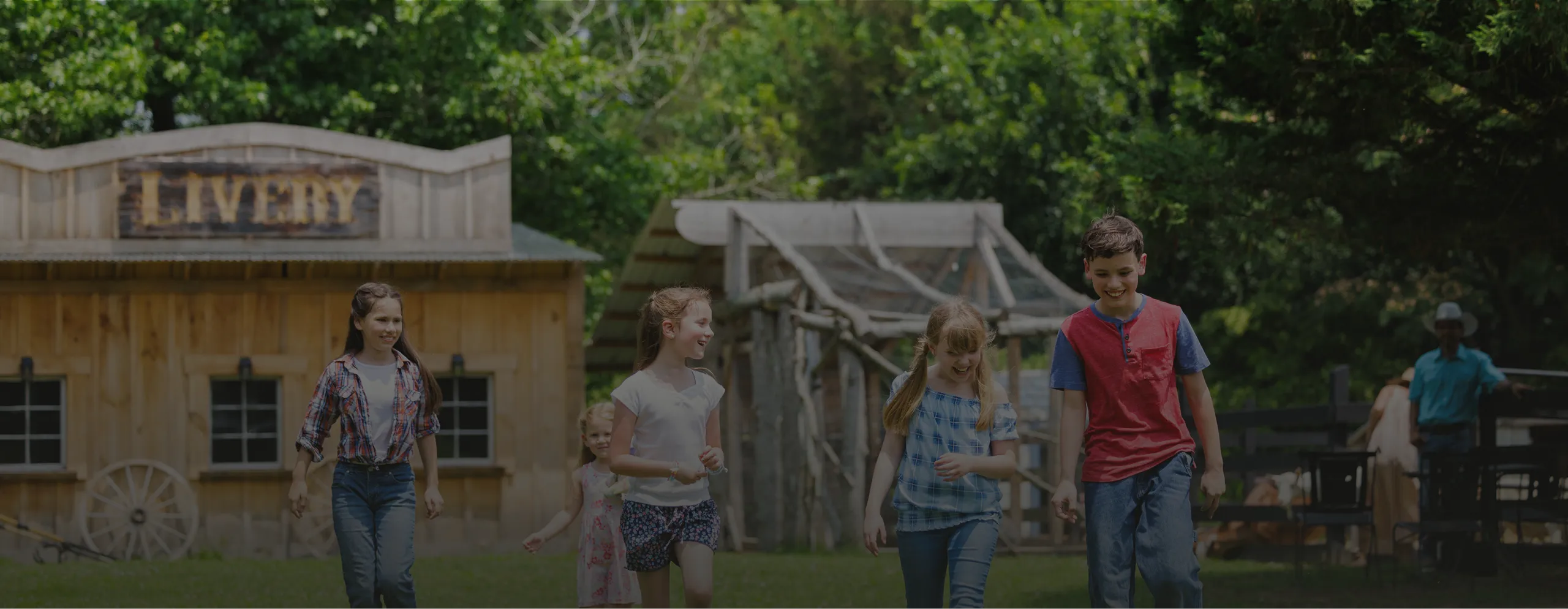 Smiling children run past the Western Frontier Town Livery building at Kay's Acres.