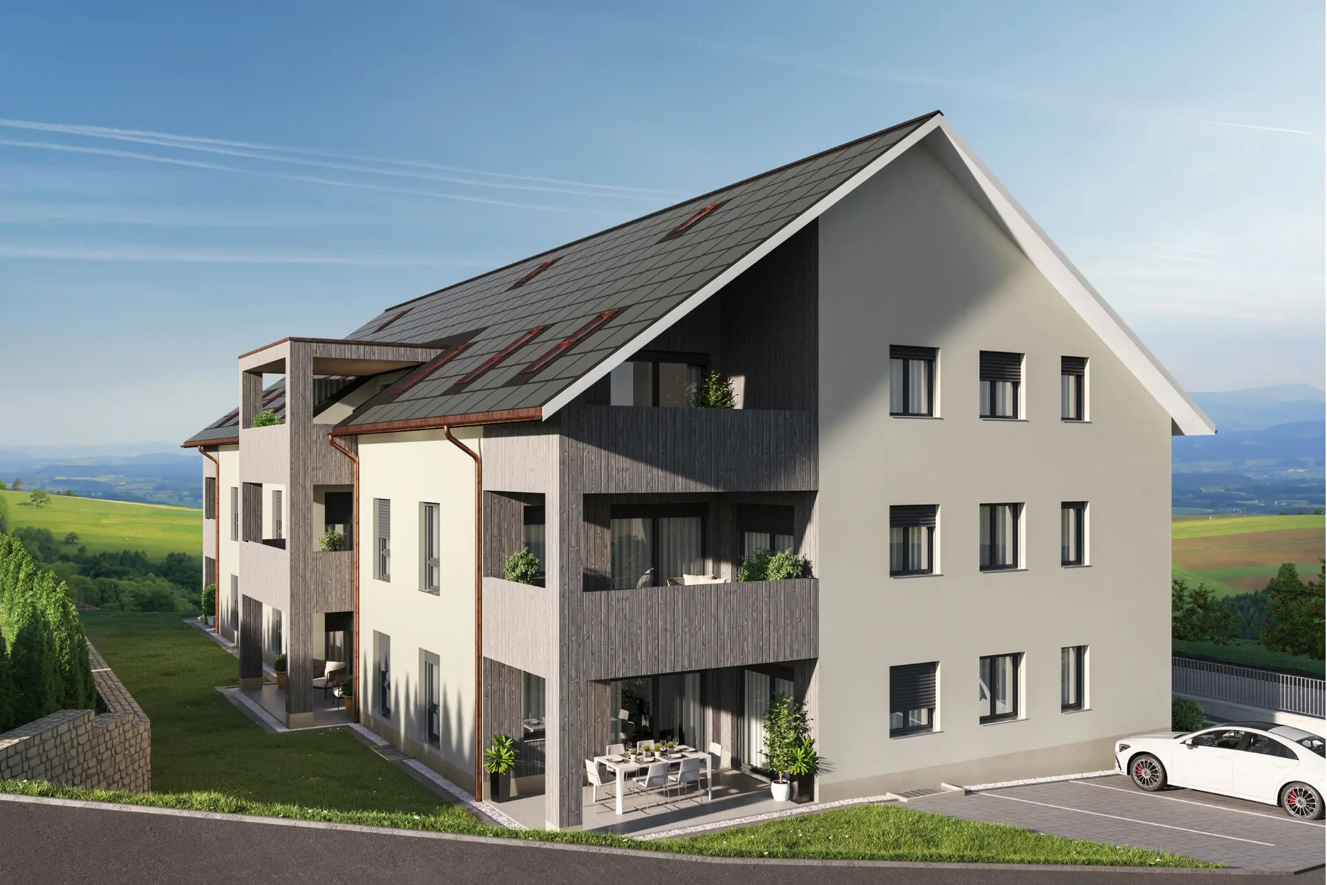 Südansicht des Mehrfamilienhauses Jägersland in Gansingen mit Holzfassade, Balkonen und Gartensitzplätzen im Erdgeschoss.