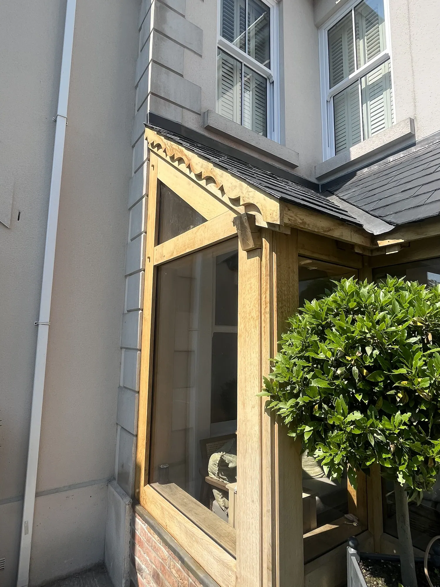 The glazed side of an oak corner porch at Llandybie