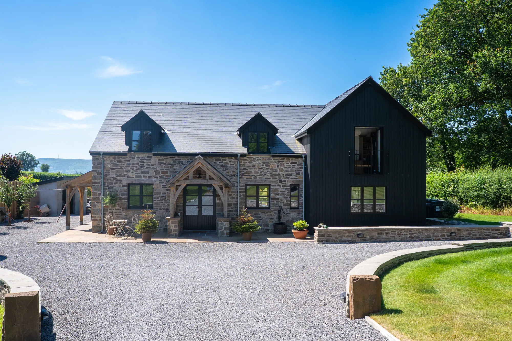 The self-built house at Llanbedr from the drive, with its oak porch at the front door.