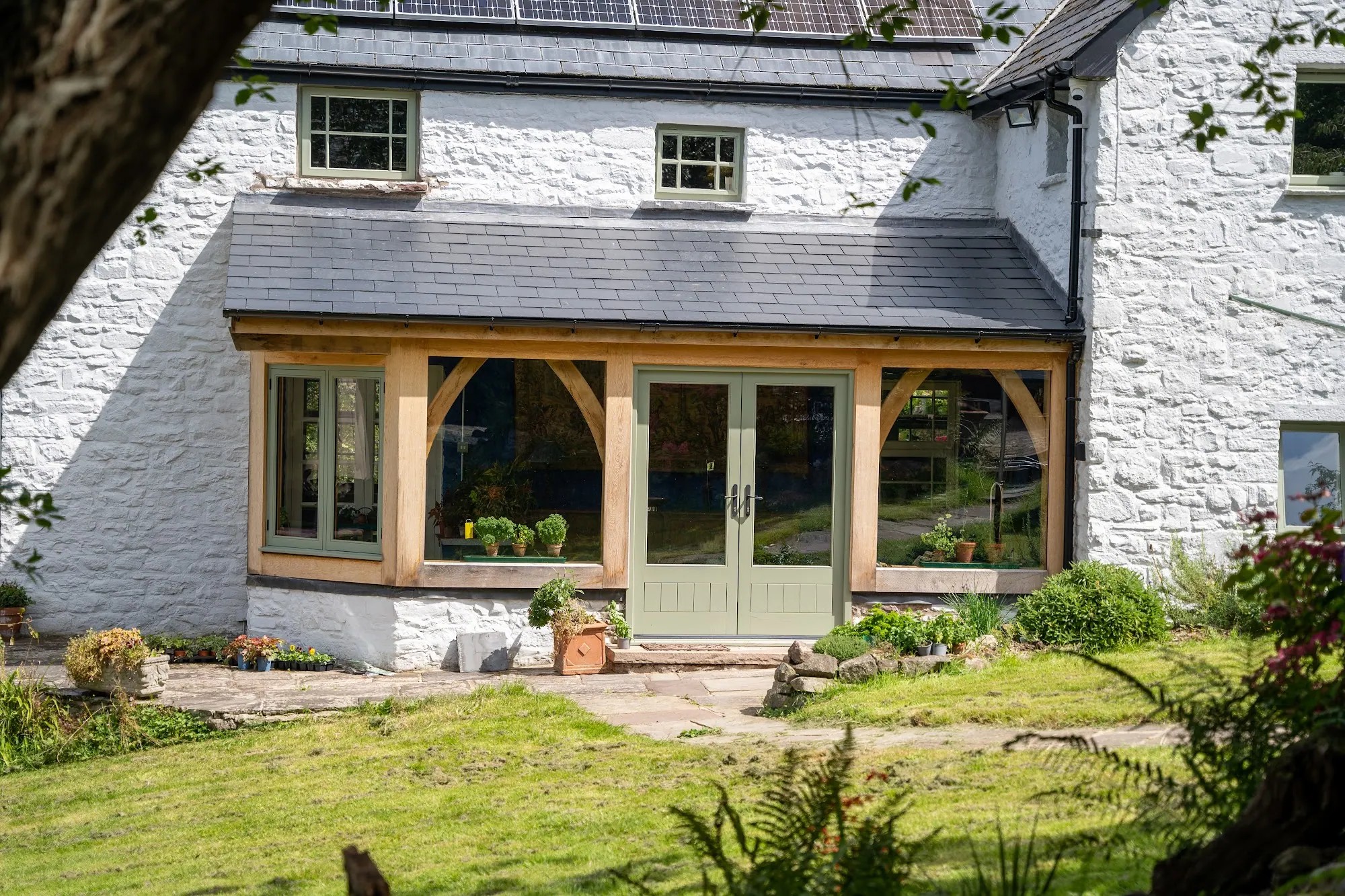 The Ty Fry extension along the side of the house, with glazed doors onto the lawn.