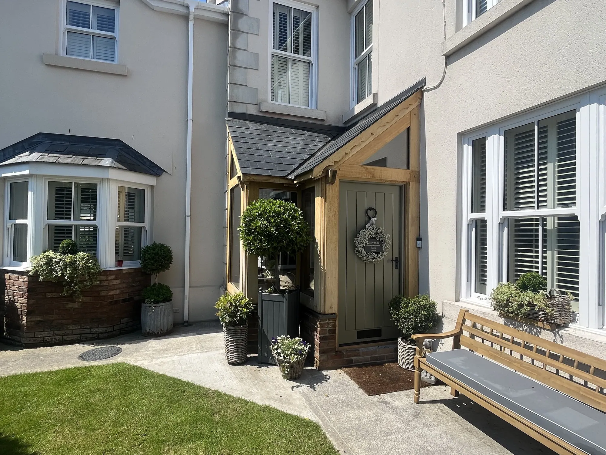 Glazed oak corner porch at Llandybie, in the courtyard beside the bay window
