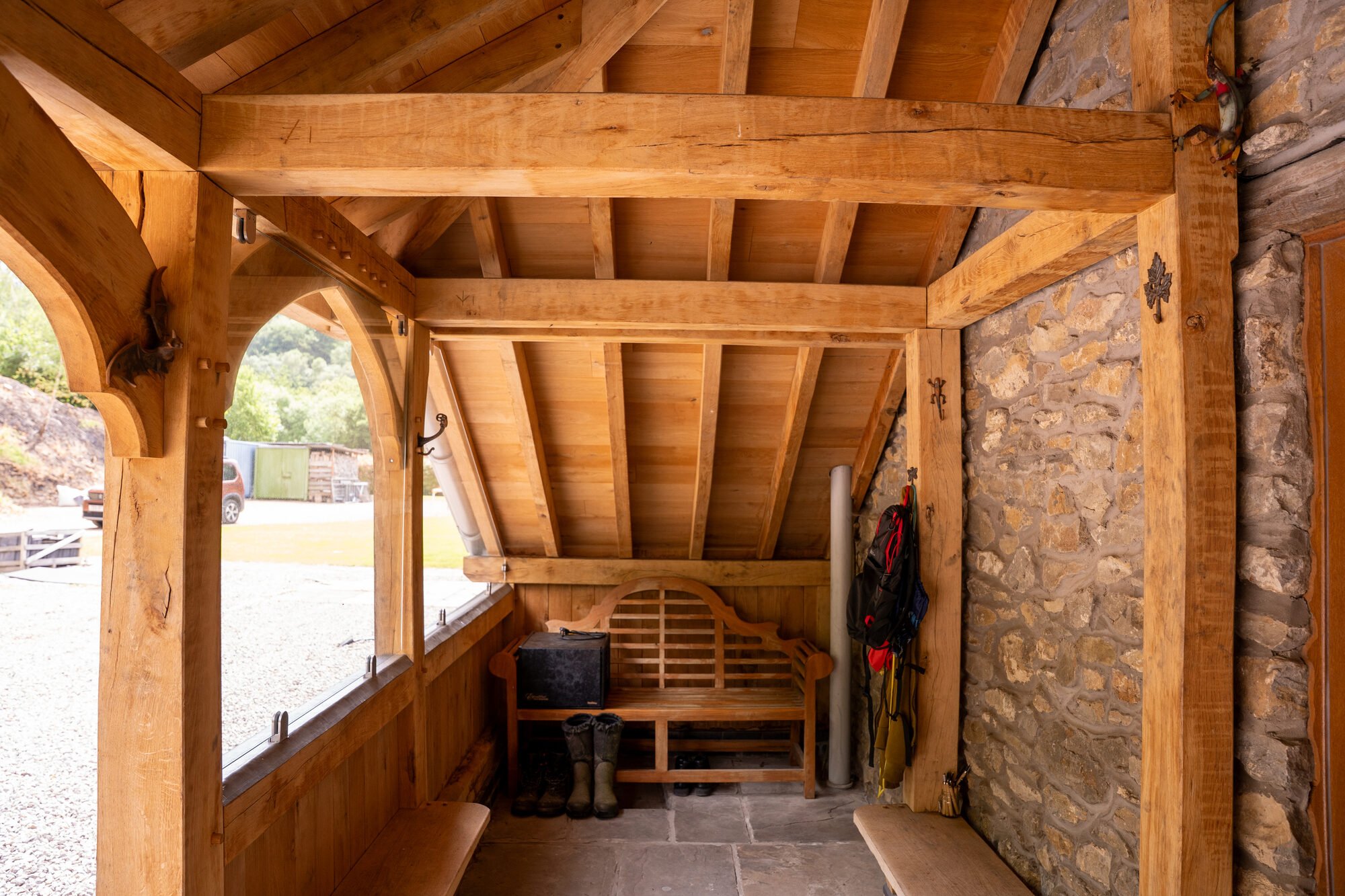 Inside an open oak porch near Usk, looking along the stone wall