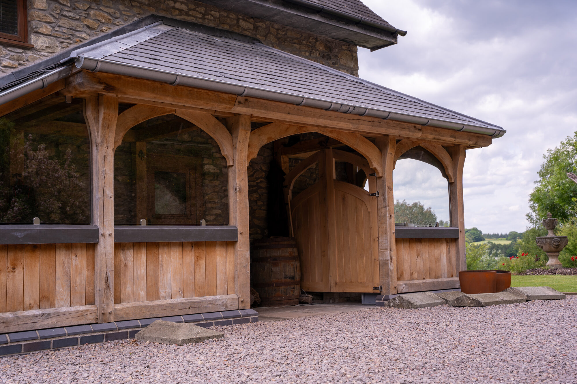 Open oak porch near Usk at an angle, with its oak door and slate roof