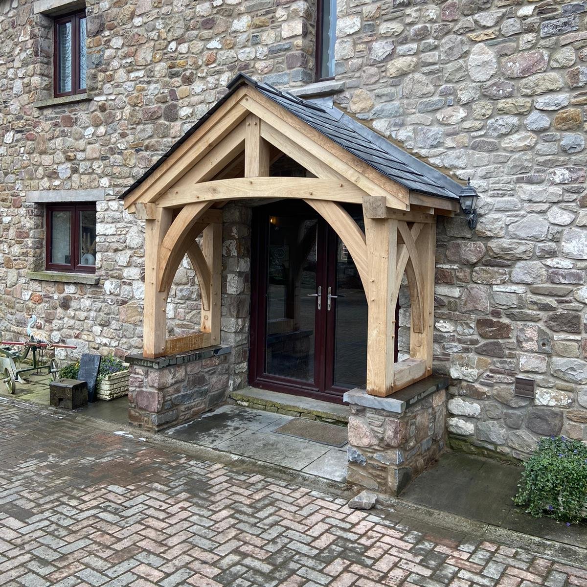 Open oak frame porch on a stone barn at Raglan