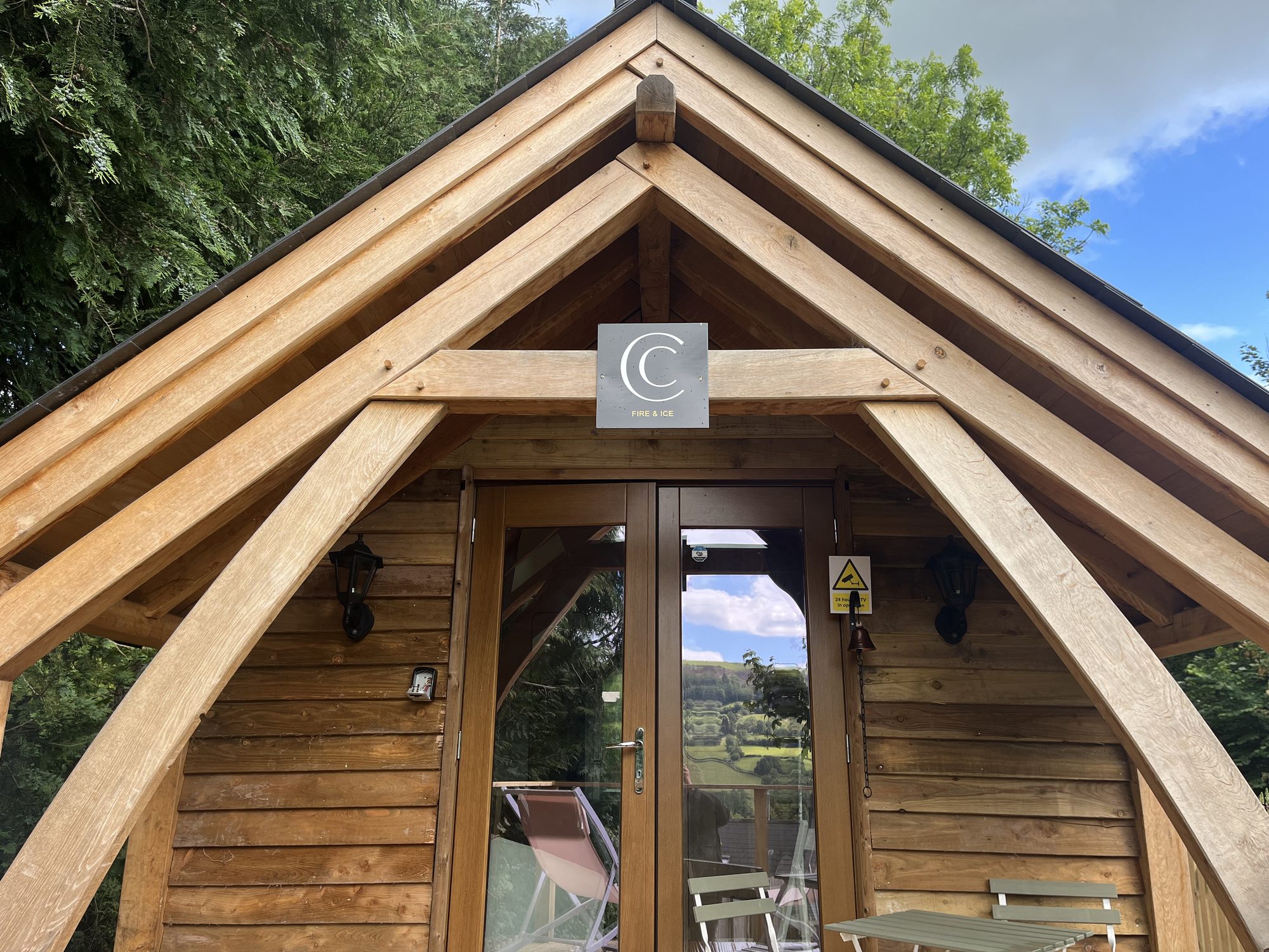 Oak entrance porch of the Cwmdu cabin, showing the gable and sling braces