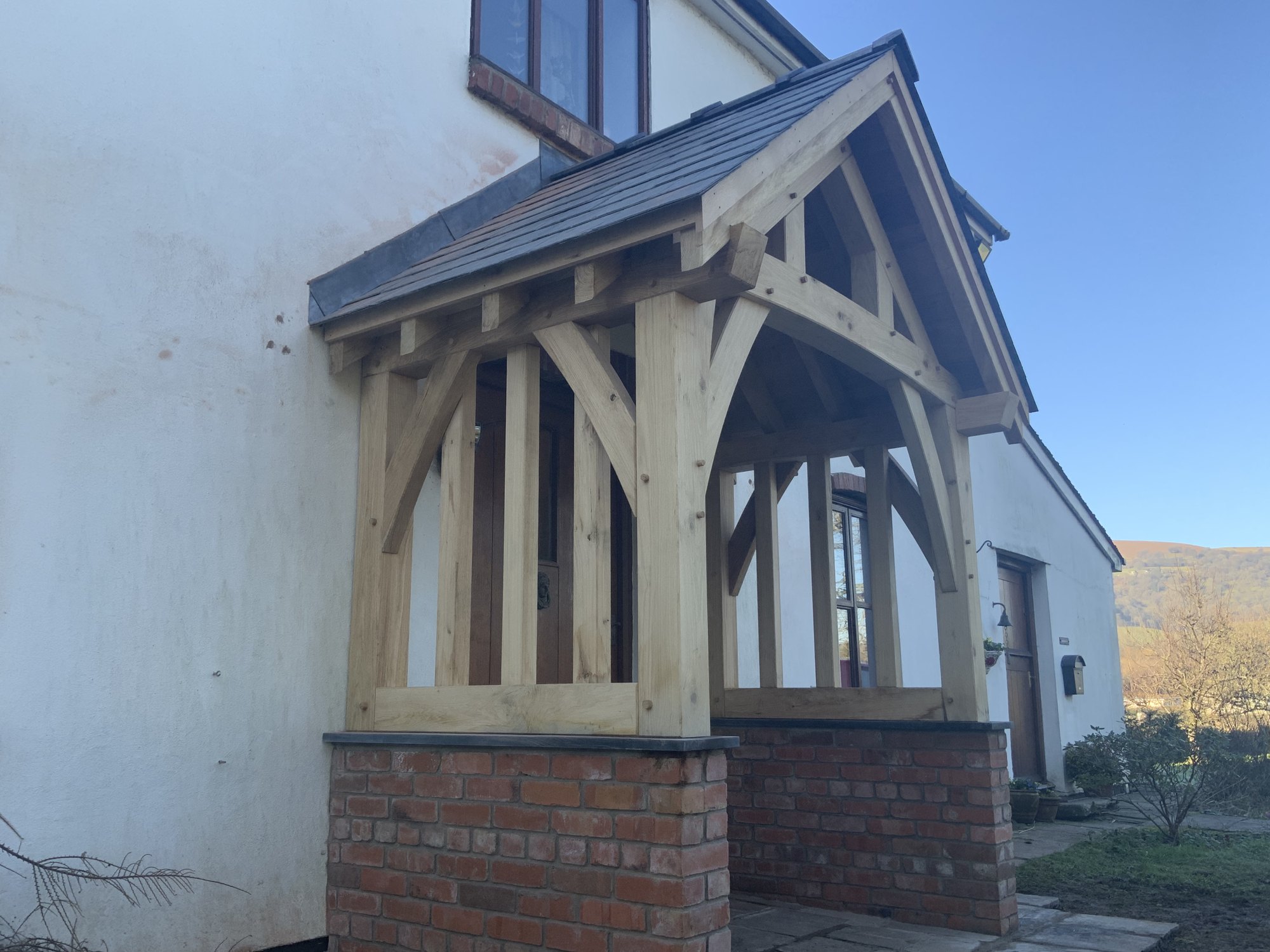 Side view of an oak gable porch at Mamhilad, with its oak balustrade and slate roof