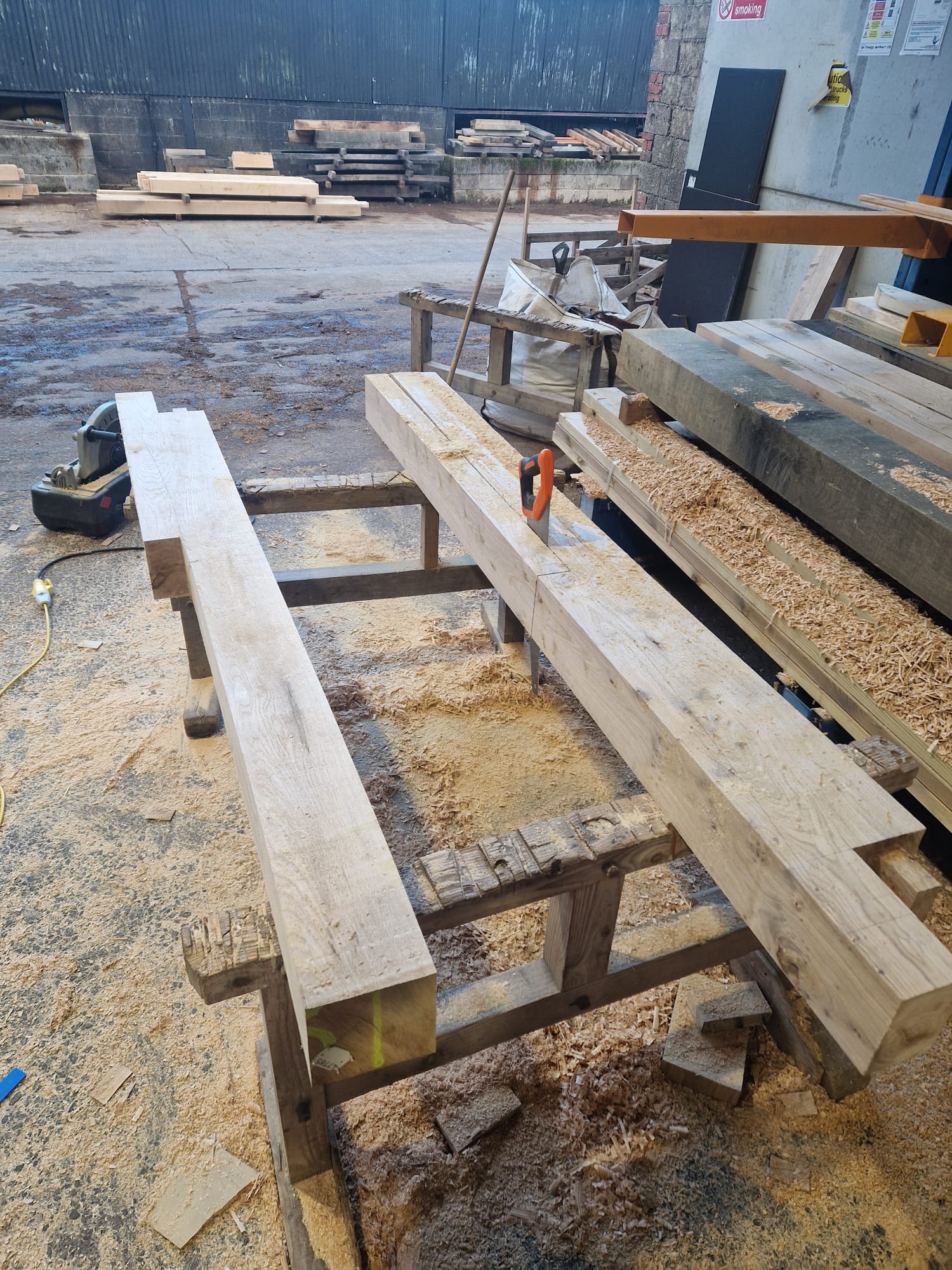 Oak porch timbers cut and laid out on trestles in the Foxtail Oak workshop