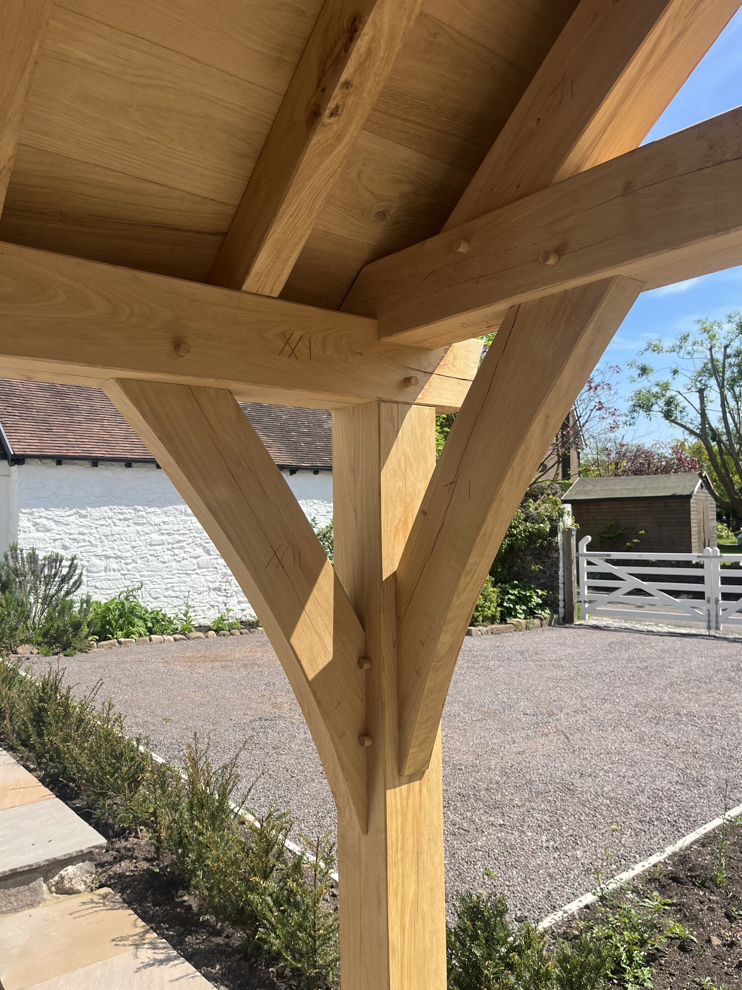 A corner post of an open oak gable porch in Abergavenny, with its braces meeting under the tie beam