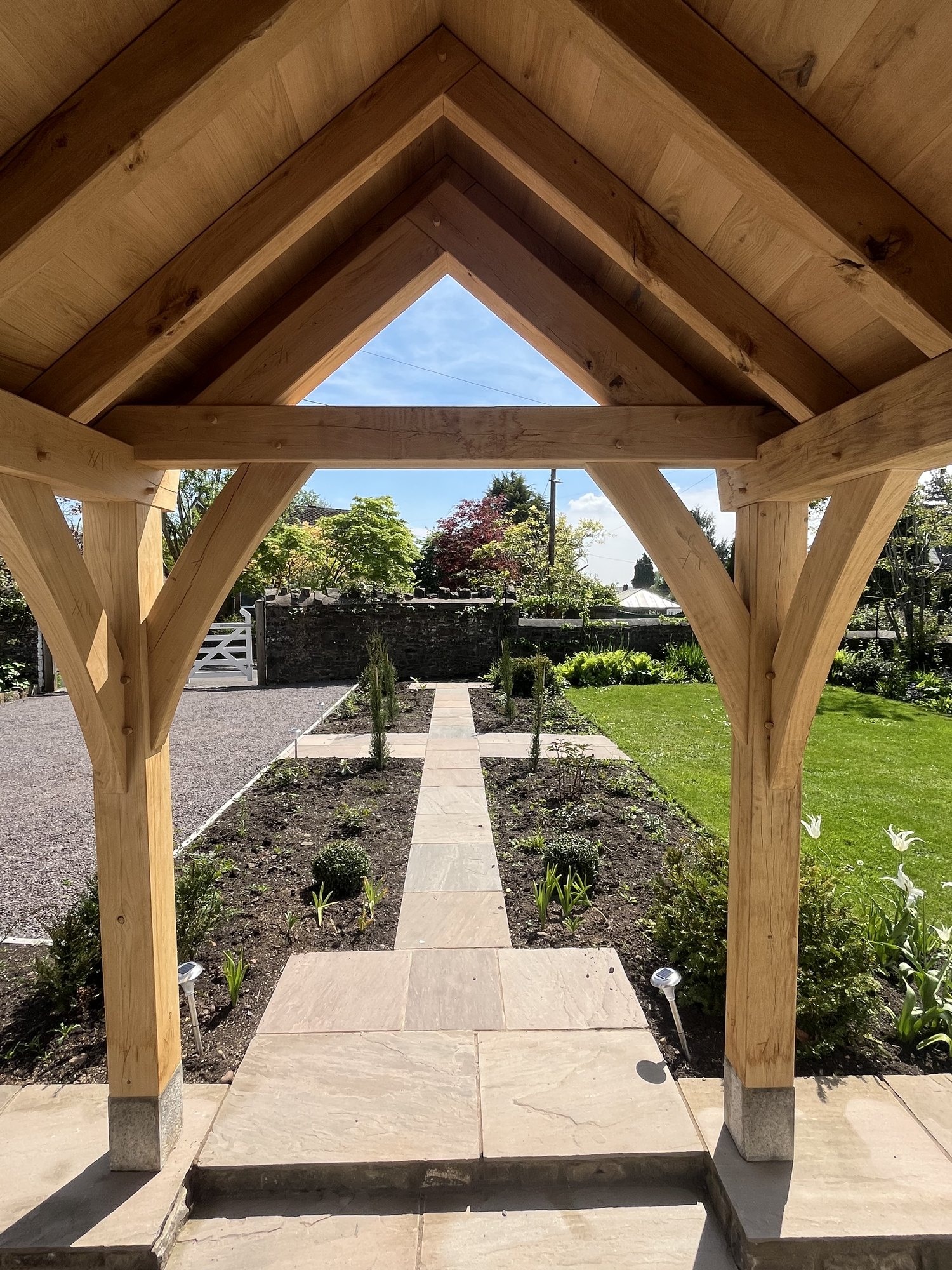 Looking out from under an open oak gable porch in Abergavenny, with oak boarding overhead
