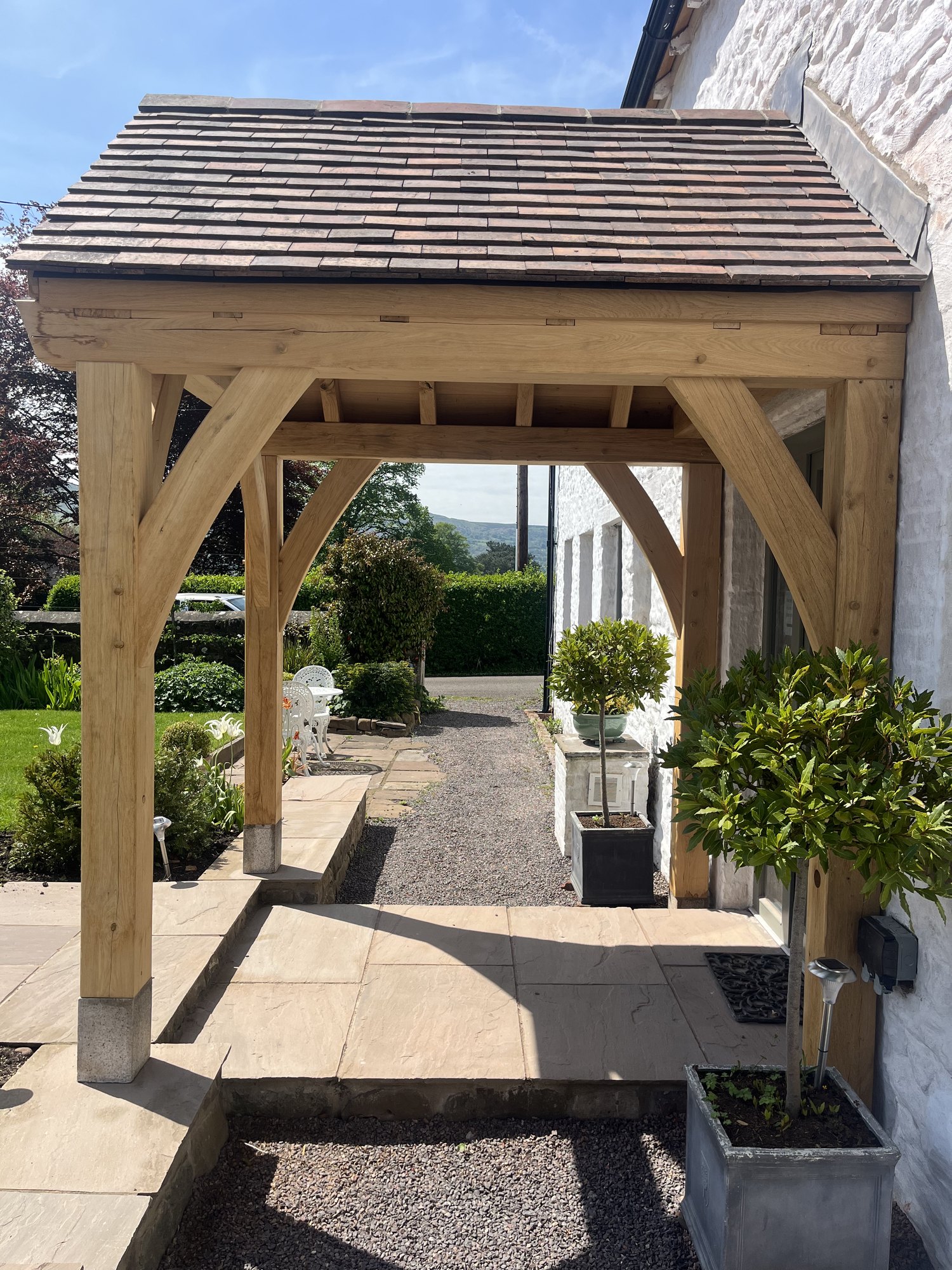 Open oak gable porch in Abergavenny seen end-on, with the path running through it
