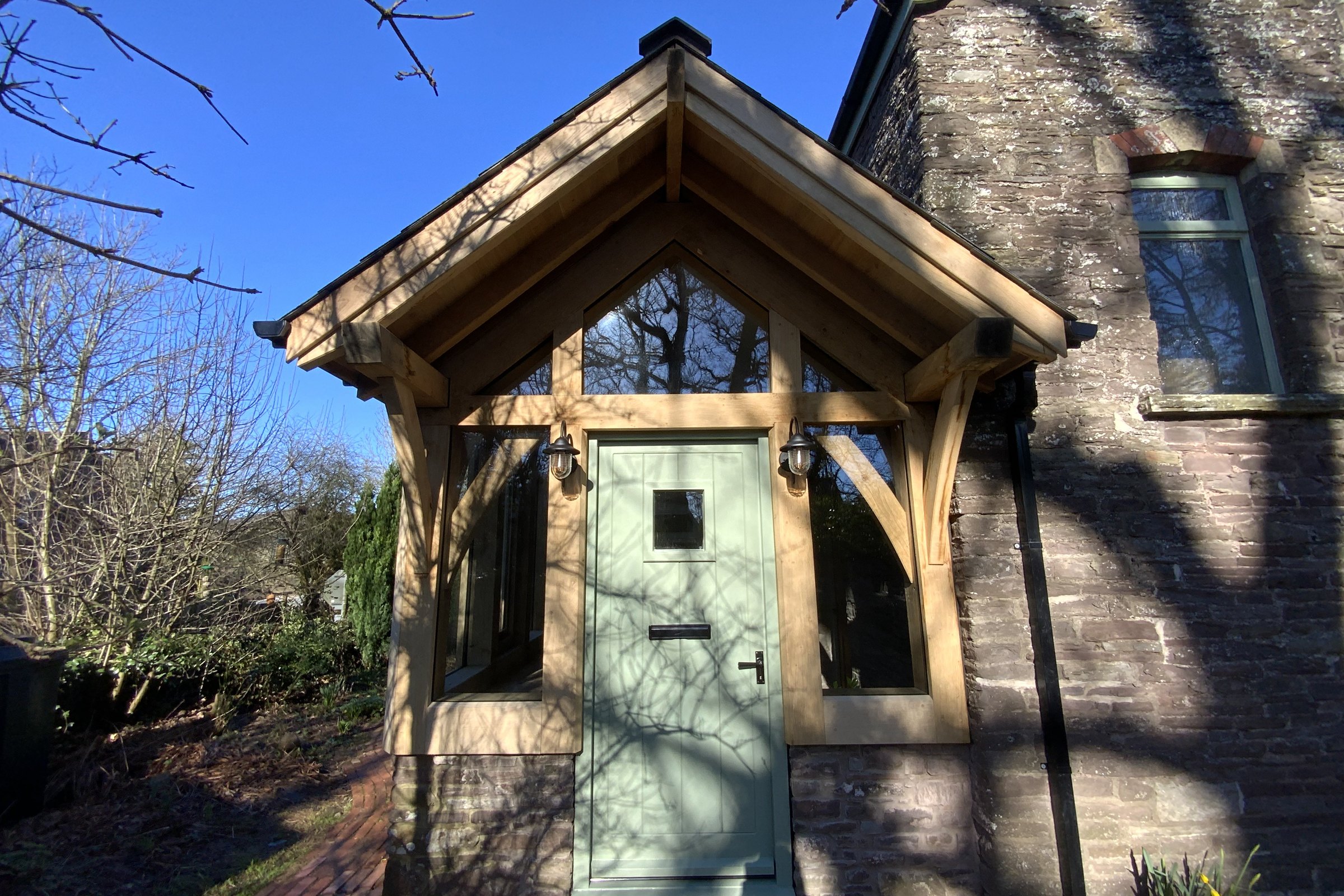 Glazed oak gable porch on a stone cottage at Llanvihangel Crucorney