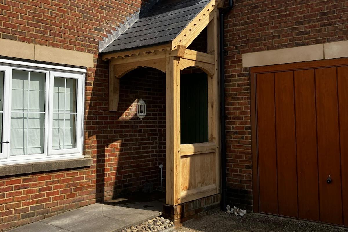 Oak gable porch with a slate roof on a brick house at Usk